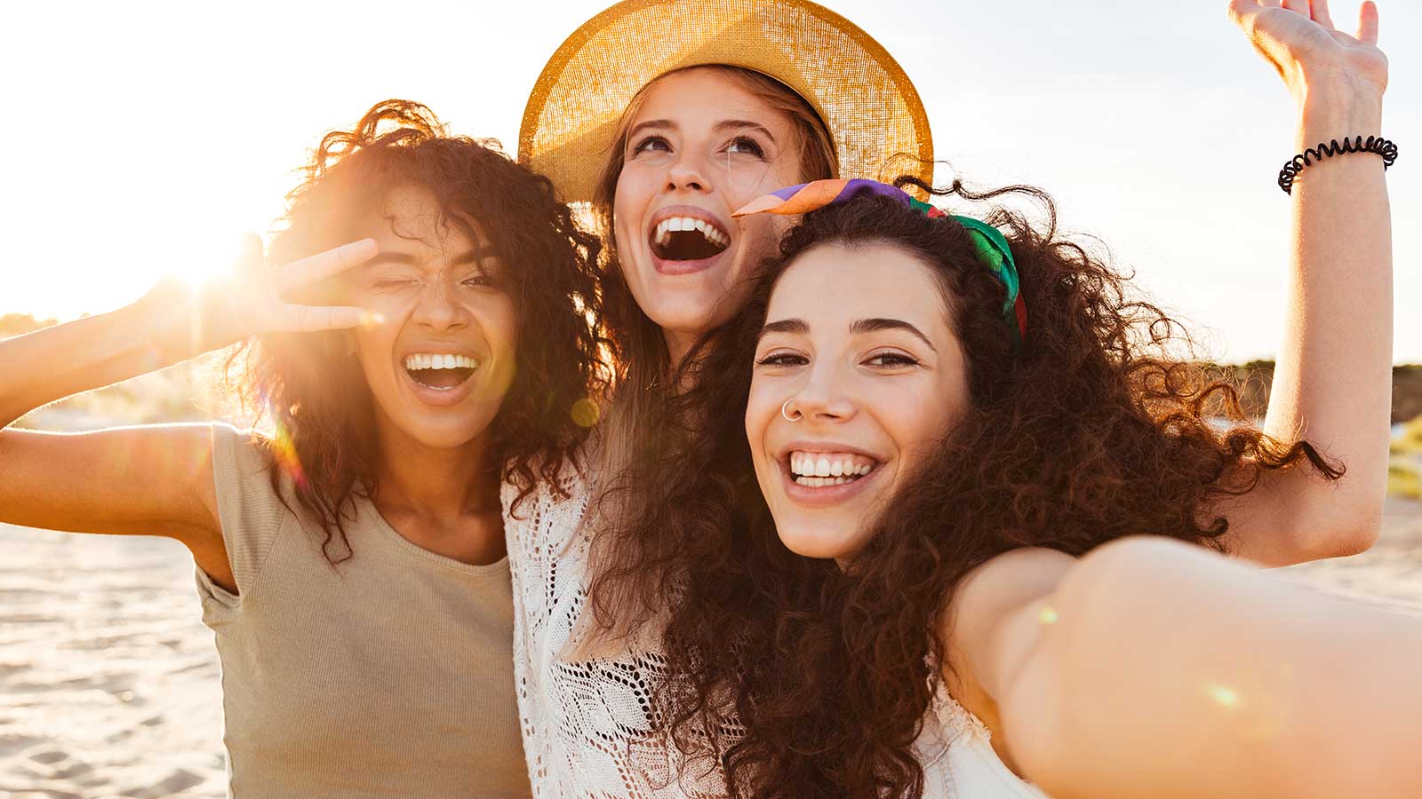 women smiling on beach