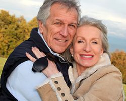 older couple smiling after learning about the longevity of the all-on-4 treatment concept from Surf City Oral and Maxillofacial Surgery in Huntington Beach, CA