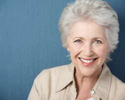 woman smiling with beautiful teeth after receiving teeth in a day procedure at Surf City Oral and Maxillofacial Surgery in Huntington Beach, CA