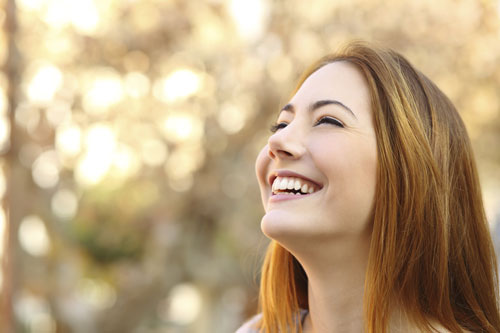 Woman smiling with her fresh dental veneers