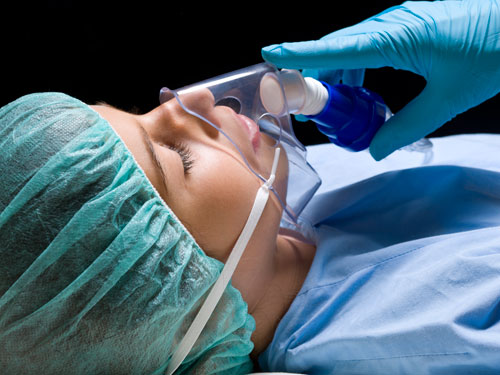 A woman being sedated on a dental chair