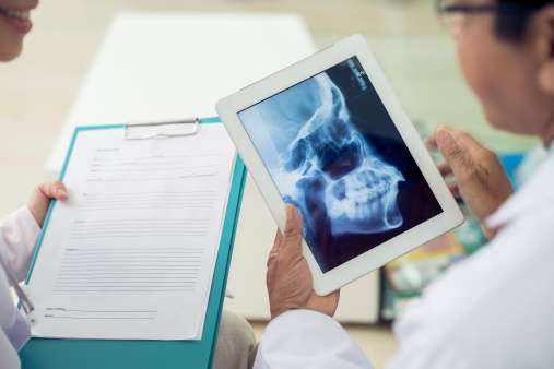 Drs. looking at xray of patient's jaw